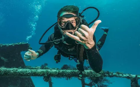 Diver exploring underwater wreck in Hurghada during professional dive trip.