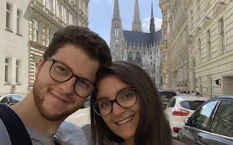 Couple in front of Votive Church, Vienna, during self-guided city exploration game.