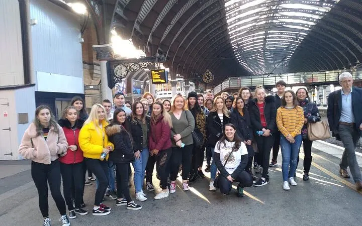 Group of tourists at York railway station for Harry Potter walking tour.