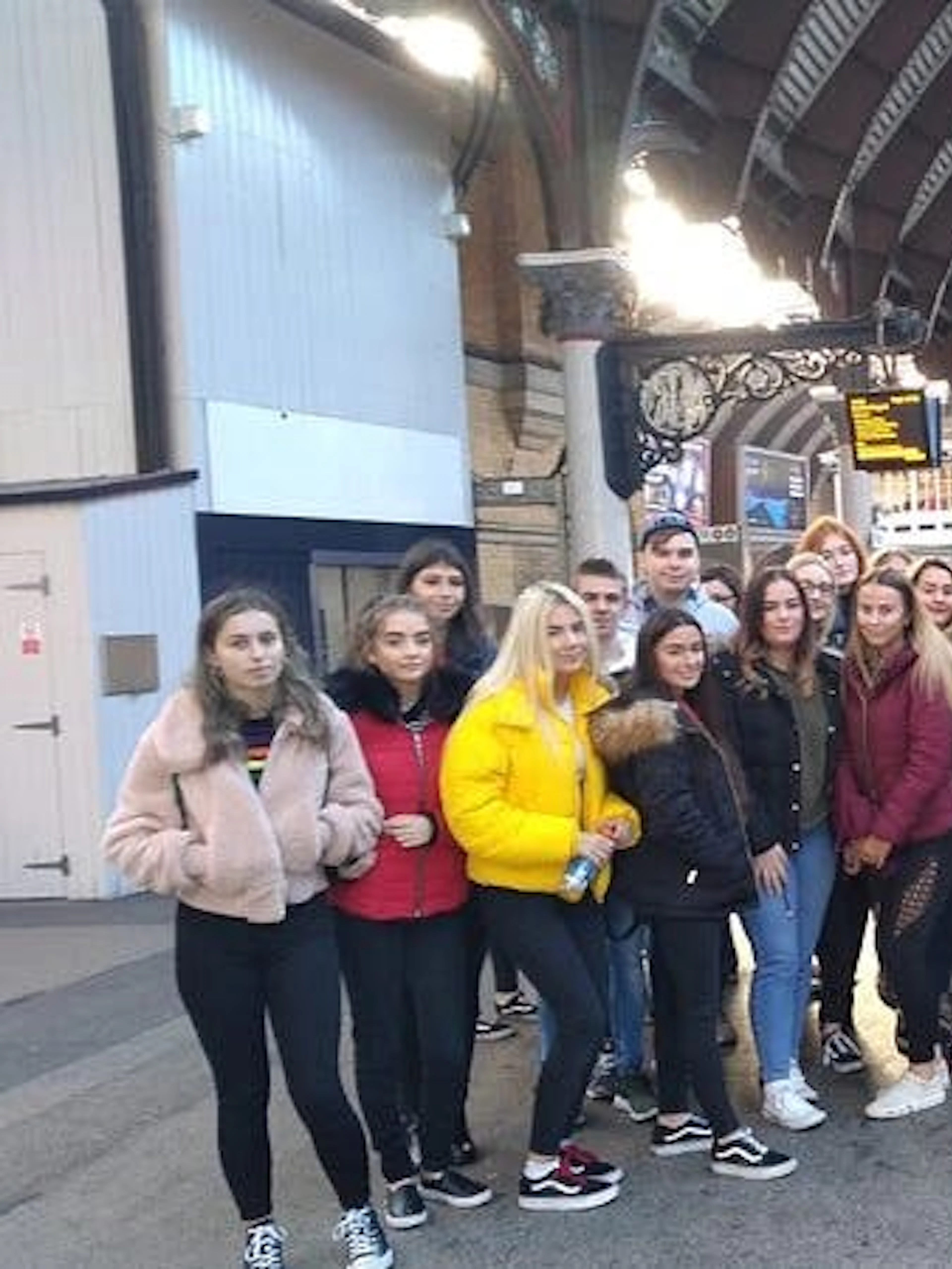 Group of tourists at York railway station for Harry Potter walking tour.