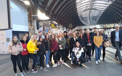 Group of tourists at York railway station for Harry Potter walking tour.