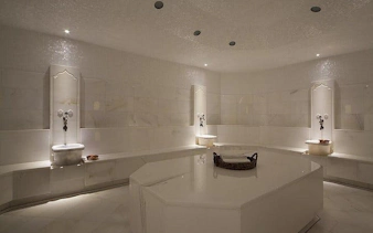 Turkish bath interior with marble benches and basins in Sharm El Sheikh spa.