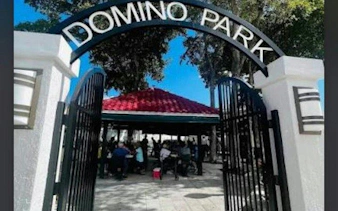 Domino Park entrance with people playing games, Little Havana, Miami.