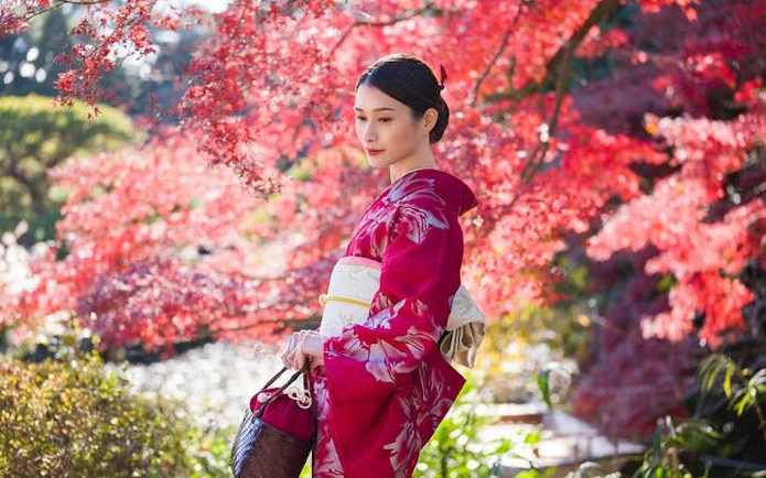 Silk kimono rental experience at Shinjuku Gyoen National Garden with autumn foliage.