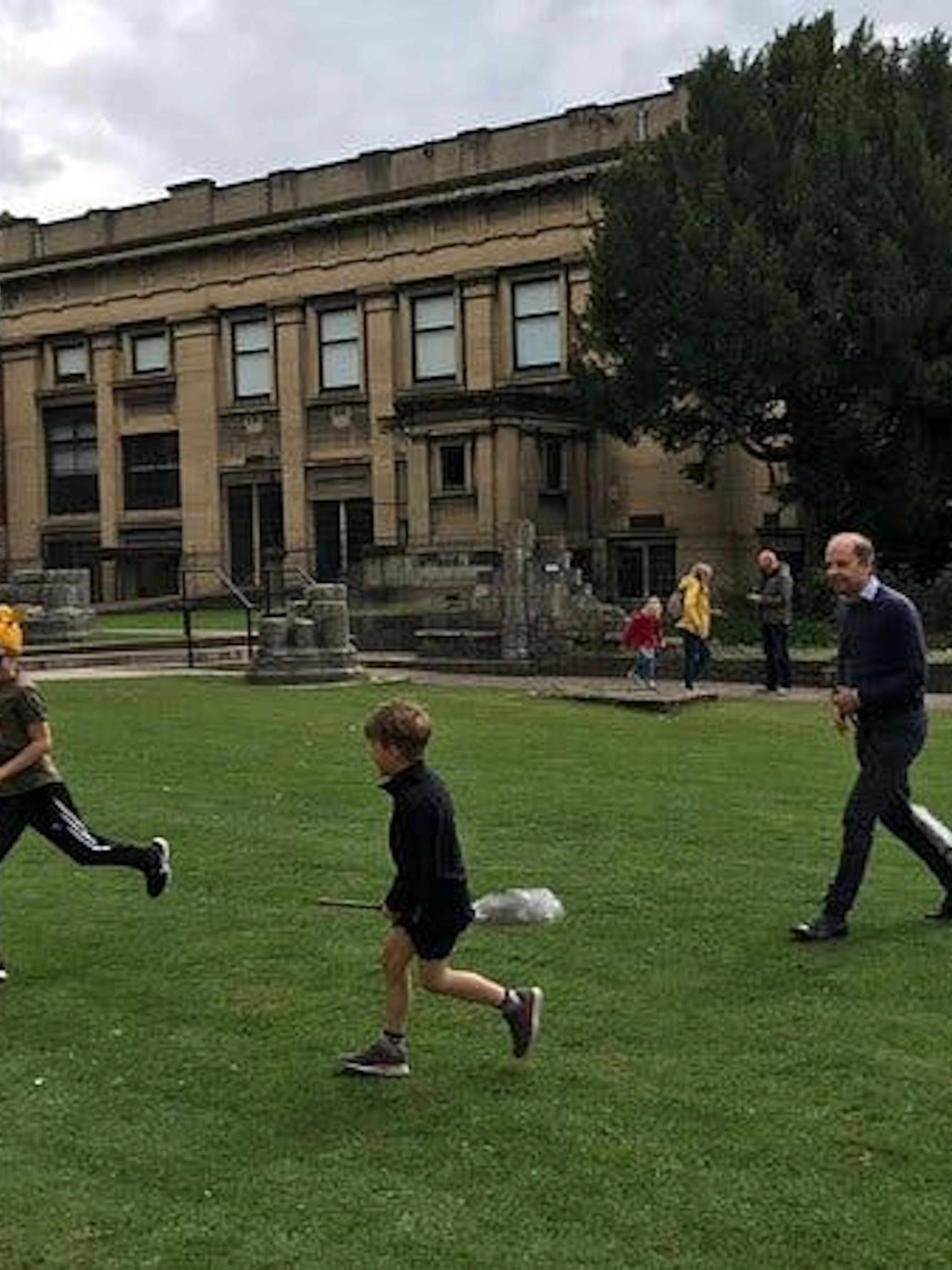 Children and adult playing a Harry Potter-themed game on a lawn in York.