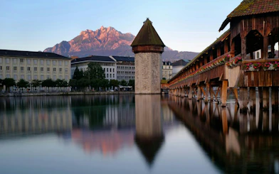 Chapel Bridge and Water Tower reflecting in the Reuss River, Lucerne Old Town.