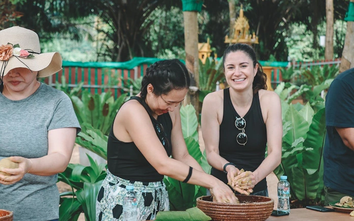 Visitors preparing food at Samui Elephant Home Nursery feeding program.
