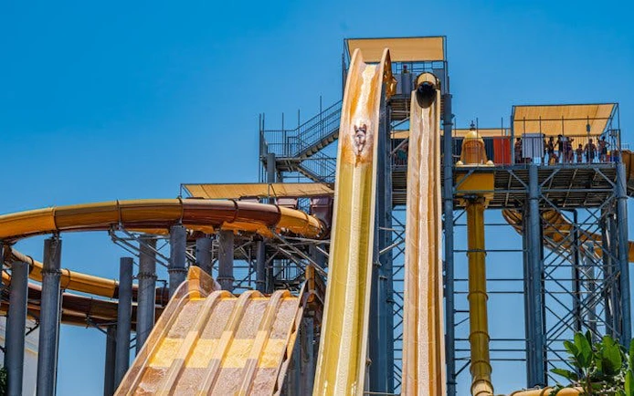 Water slides at The Land of Legends Theme Park, Turkey, with people enjoying the ride.