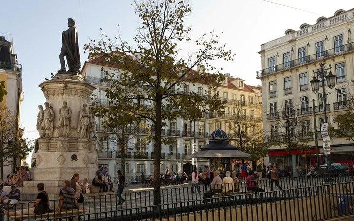 Lisbon city square with statue and historic buildings on a private full-day tour.