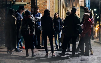 Group gathered for Bath Ghost Walk storytelling tour at night.