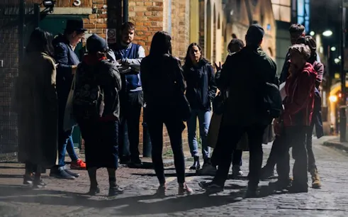 Group gathered for Bath Ghost Walk storytelling tour at night.