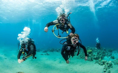 Scuba divers exploring coral reefs in Hurghada during a two-stop diving trip.