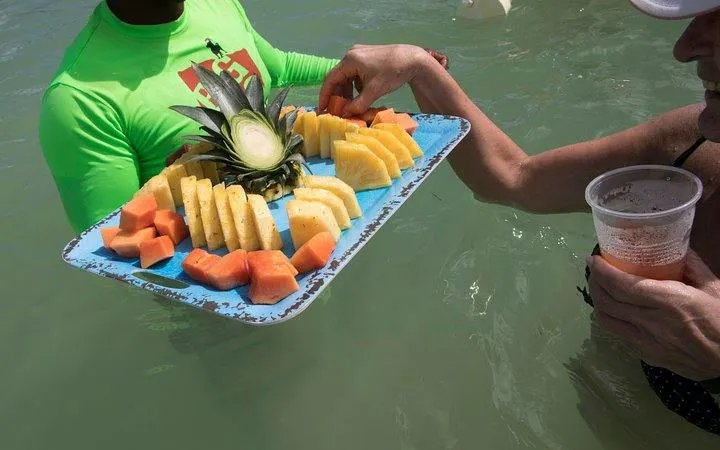 Floating bar with fresh fruit platter on catamaran cruise, Punta Cana.