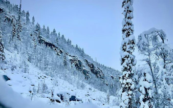 Korouoma Canyon covered in snow, showcasing frozen waterfalls and snowy trees, Rovaniemi.