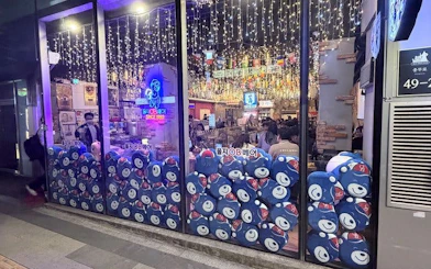Seoul restaurant with festive lights, offering chimaek experience with fried chicken and beer.