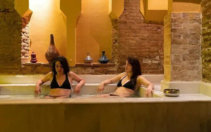 Women relaxing in a traditional Moroccan hammam bath in Marrakesh.
