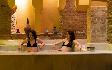 Women relaxing in a traditional Moroccan hammam bath in Marrakesh.