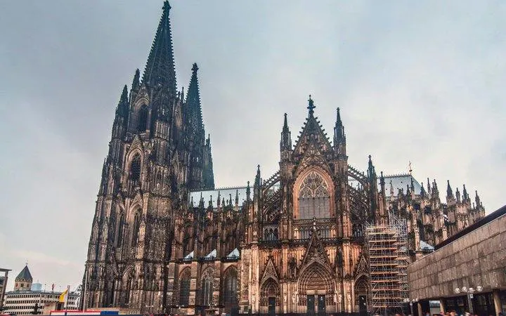 Cologne Cathedral exterior view on a cloudy day during a self-guided walking tour.