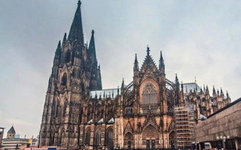 Cologne Cathedral exterior view on a cloudy day during a self-guided walking tour.