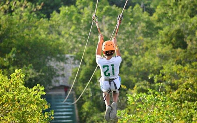 Ziplining through lush forest in Punta Cana adventure tour.