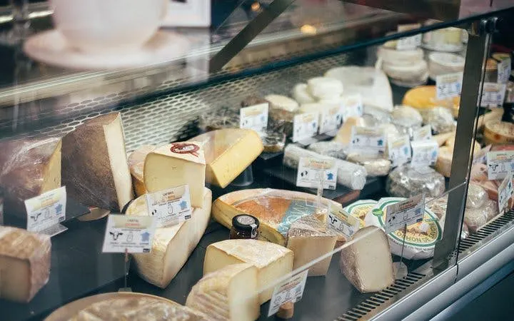 Cheese selection in Edinburgh shop for guided food tour with tastings and quizzes.