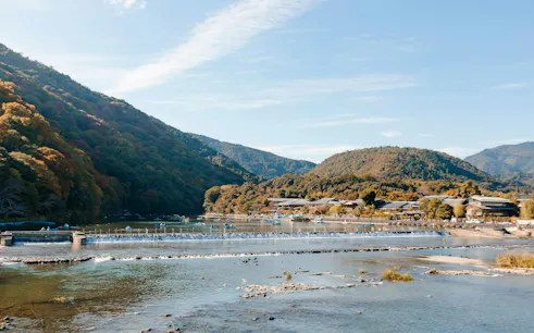 Togetsukyo Bridge over Katsura River with Arashiyama mountains in Kyoto.