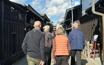 Group walking through Takayama's historic old town street on a private tour.