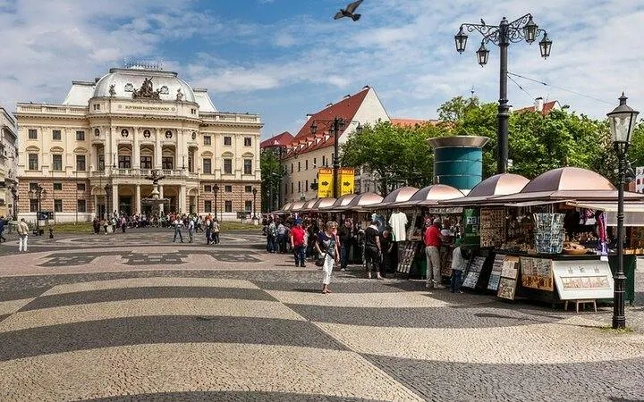 Bratislava city square with historic building and market stalls, part of self-guided audio tour.