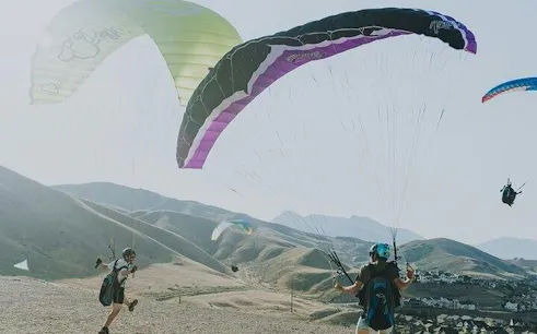 Paragliders preparing to launch over Atlas Mountains near Marrakech.