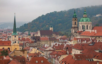 Prague cityscape with St. Nicholas Church and red rooftops on a self-guided walking tour.