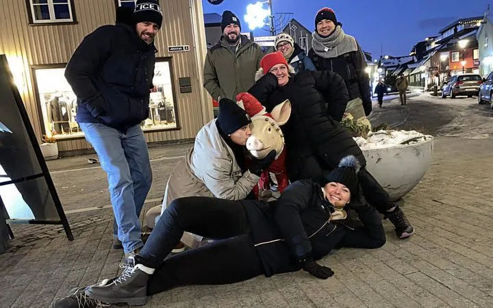 Group enjoying Icelandic food tour with cultural insights in a lively street setting.
