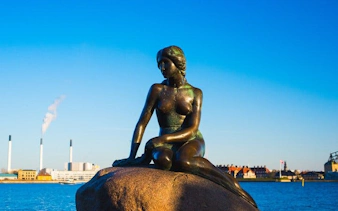 Little Mermaid statue on a rock by the waterfront in Copenhagen.