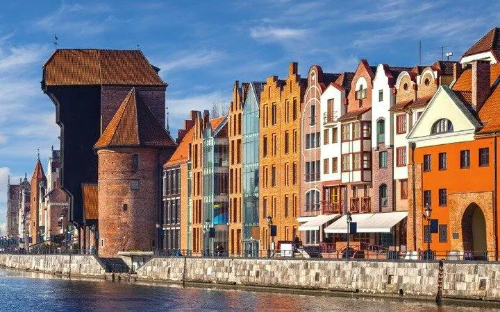 Colorful historic buildings along the Motława River in Gdansk, featured in a self-guided audio tour.
