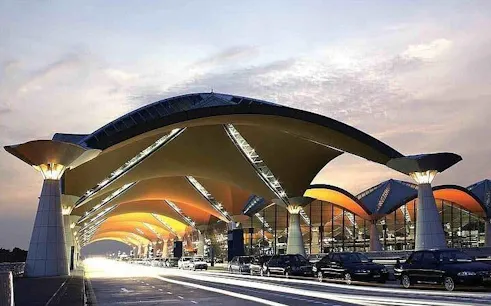 Kuala Lumpur International Airport terminal with cars for private city hotel transfer.