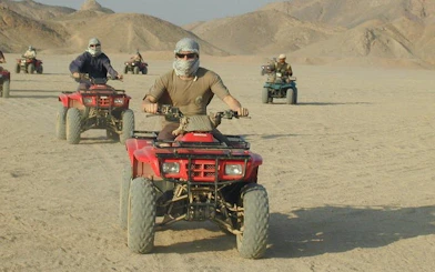 Quad biking group in Hurghada desert during safari tour.