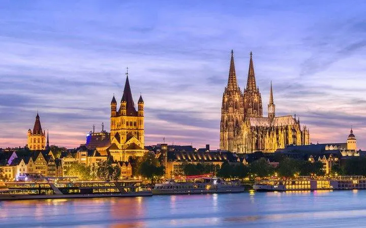 Cologne Cathedral and city skyline at dusk, view from the Rhine River, Cologne.
