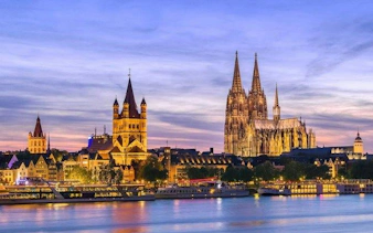 Cologne Cathedral and city skyline at dusk, view from the Rhine River, Cologne.