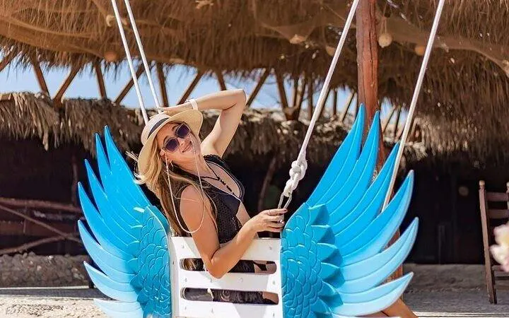 Swing with blue wings at beachside hut, Hula Hula Island, Hurghada.