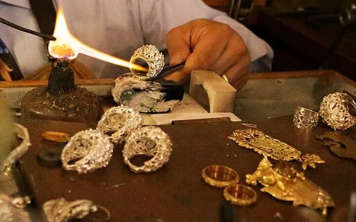 Artisan crafting jewelry in Florence workshop with guided demonstrations.