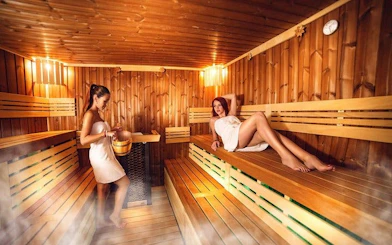 Women relaxing in a wooden sauna, Hurghada Turkish bath experience.