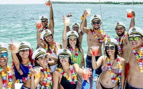 Group enjoying drinks on a yacht cruise along Punta Cana Bavaro Coast.
