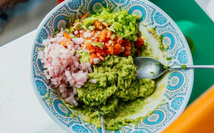 Guacamole with diced onions, tomatoes, and peppers served on a Punta Cana catamaran cruise.