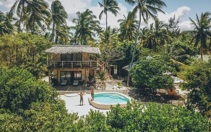 Tropical villa with pool surrounded by palm trees in Zanzibar, Tanzania.