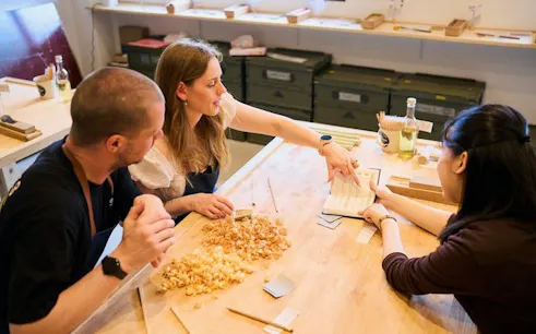 Participants crafting chopsticks at a workshop in Kyoto's Arashiyama.