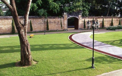 Pathway leading to a historic brick wall in Chiang Rai City.