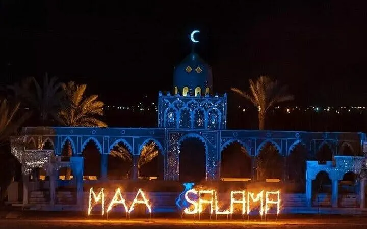 Chez Ali Fantasia show with illuminated arches and palm trees in Marrakesh.