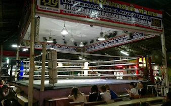 Thapae Stadium Muay Thai boxing ring in Chiang Mai with spectators seated nearby.