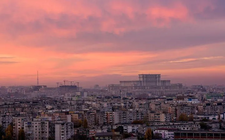 Bucharest skyline at sunset with Palace of the Parliament in view.