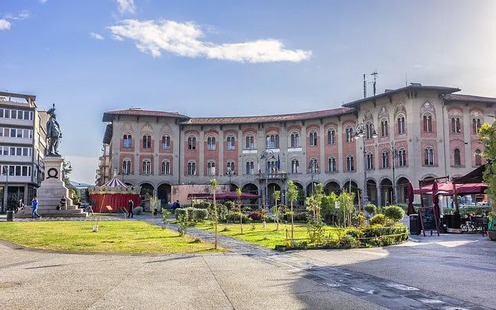Piazza dei Cavalieri in Pisa with historical buildings and statue, Italy.