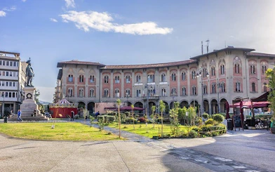 Piazza dei Cavalieri in Pisa with historical buildings and statue, Italy.